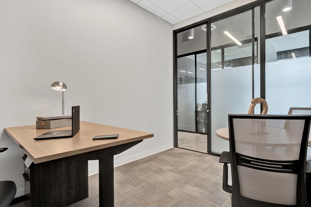 Interior office with glass wall facing windowline